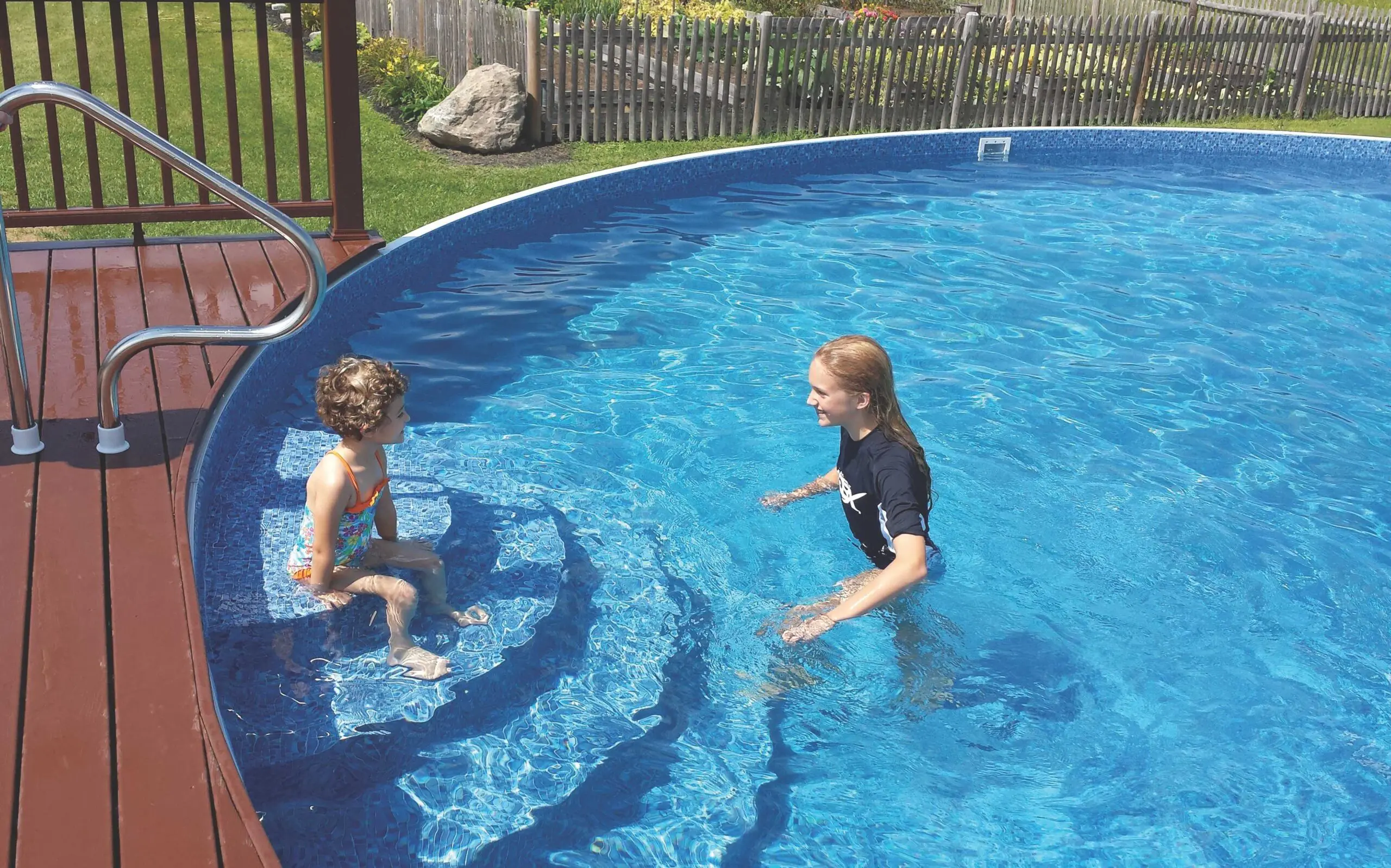Family enjoying above-ground pool in New England backyard
