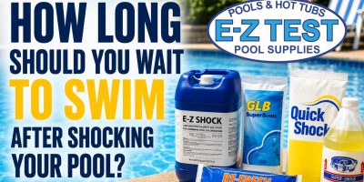 Pool shock products beside an above-ground swimming pool illustrating how long to wait before swimming after shocking your pool.